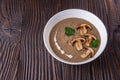 Mushroom cream soup on rustic wooden background