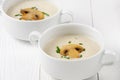 Mushroom cream soup in white bowls on wooden boards Royalty Free Stock Photo