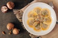 Mushroom filled ravioli pasta, overhead scene on stone background Royalty Free Stock Photo