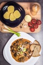 Mushroom goulash served with bread, potato dumpling and onion