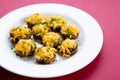 Mushroom halves stuffed and topped with melted cheese