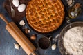 Mushroom pie with spice, champignons, black pepper and eggs on the photo. Bottle with oil. fork and other cutlery are near the pie