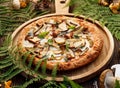 Mushroom pizza, pizza with addition of edible forest mushrooms porcini mushrooms, chanterelle and mozzarella cheese and herbs on Royalty Free Stock Photo