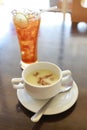 Mushroom soup bowl and glass of iced lemon tea.