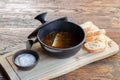 Mushroom soup in cast iron pot next to sauce ond bread Royalty Free Stock Photo