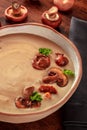 Mushroom soup with ingredients, on a rustic wooden table Royalty Free Stock Photo