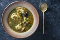 Mushroom soup plate with porcini mushrooms, dumplings, potato, carrot, onion, fresh green dill and pepper on black background, Royalty Free Stock Photo