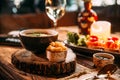 Mushroom soup puree in a bowl with crackers on the wooden board and prosciutto bruschettas Royalty Free Stock Photo