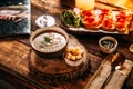 Mushroom soup puree in a bowl on the wooden board and prosciutto bruschettas Royalty Free Stock Photo