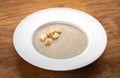 Mushroom soup puree with croutons and mushrooms on a wooden Royalty Free Stock Photo