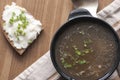 Mushroom soup served with lard spread with green onion