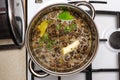 Mushroom soup with vegetables boiled in a metal pot on a gas stove, top view. Royalty Free Stock Photo