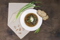 Mushroom soup with wild mushrooms, vegetables, green onions, garlic and homemade sour cream. Traditional dish, top view Royalty Free Stock Photo