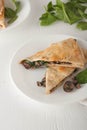 Mushroom spinach quesadilla on white plate Royalty Free Stock Photo