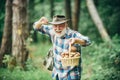 Mushrooming in forest, Grandfather hunting mushrooms over summer forest background. Royalty Free Stock Photo