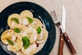 Mushrooms agnolotti on blue plate. Traditional dish of italian cuisine