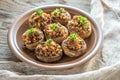 Mushrooms' caps stuffed with cheese, onion and butter