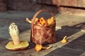 Mushrooms chanterelles collected in a basket handmade. Basket of lime bark with mushrooms, standing on an old wooden background Royalty Free Stock Photo