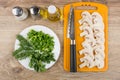 Mushrooms on cutting board, spices, bottle of vegetable oil, gre Royalty Free Stock Photo