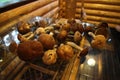 Mushrooms lie on a glass table in a wooden house