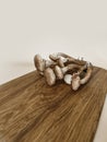 Mushrooms are lying on a wooden board. Autumn forest still life in beige colors Royalty Free Stock Photo