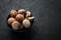 Mushrooms in a plate. Champignons on the old background. Top view. Royalty Free Stock Photo