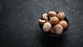 Mushrooms in a plate. Champignons on the old background. Top view. Royalty Free Stock Photo