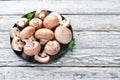 Mushrooms in a plate. Champignons on the old background. Top view. Royalty Free Stock Photo