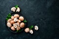 Mushrooms in a plate. Champignons on the old background. Top view. Royalty Free Stock Photo