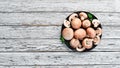 Mushrooms in a plate. Champignons on the old background. Top view. Royalty Free Stock Photo