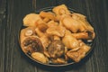 Mushrooms on plate. Pickled mushrooms in a plate. On wooden background