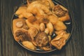 Mushrooms on plate. Pickled mushrooms in a plate. On wooden background