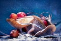 Mushrooms and red berries in snow and frost on a blue background. Christmas artistic image