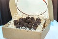 Mushrooms truffles on wooden shavings in a cardboard box on the table