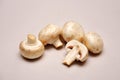 Whole and sliced button mushrooms on a seamless background Royalty Free Stock Photo