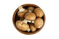 Mushrooms in wooden bowl isolated on white background, top view. Fresh brown champignons. Uncooked food ingredient Royalty Free Stock Photo