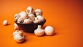 Mushrooms in a wooden bowl on an orange background. The small white champignon in a plate and scattered near it Royalty Free Stock Photo