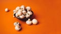 Mushrooms in a wooden bowl on an orange background. The small white champignon in a plate and scattered near it. Royalty Free Stock Photo