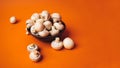 Mushrooms in a wooden bowl on an orange background. The small white champignon in a plate and scattered near it Royalty Free Stock Photo