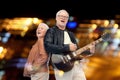 Happy senior couple with electric guitar singing Royalty Free Stock Photo