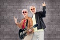 Senior couple with guitar showing rock hand sign Royalty Free Stock Photo