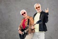 Senior couple with guitar showing rock hand sign Royalty Free Stock Photo