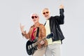 Senior couple with guitar showing rock hand sign Royalty Free Stock Photo