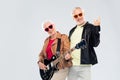 Senior couple with guitar showing rock hand sign Royalty Free Stock Photo