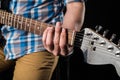 Music and art. Electric guitar in the hands of a guitarist, on a black isolated background. Playing guitar. Horizontal frame Royalty Free Stock Photo