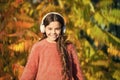 Music for autumn mood. Kid girl relaxing near autumn tree with headphones. Listening song. Enjoy music fall day. Autumn