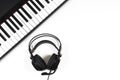 Music background. Black digital piano and headphones with microphone on white background. Top view Royalty Free Stock Photo