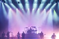 Music Band on Stage, Silhouettes at a Music Concert in Front of Bright Lights. Vintage Style. The Concept of Active Nightlife,