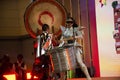 Music band thai acting musician playing gong drum set and dancing to the beat for show thai people and foreign guest on stage in