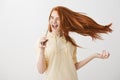 Music boosts confidence and happiness. Portrait of emotive charming woman with red hair dancing and singing song